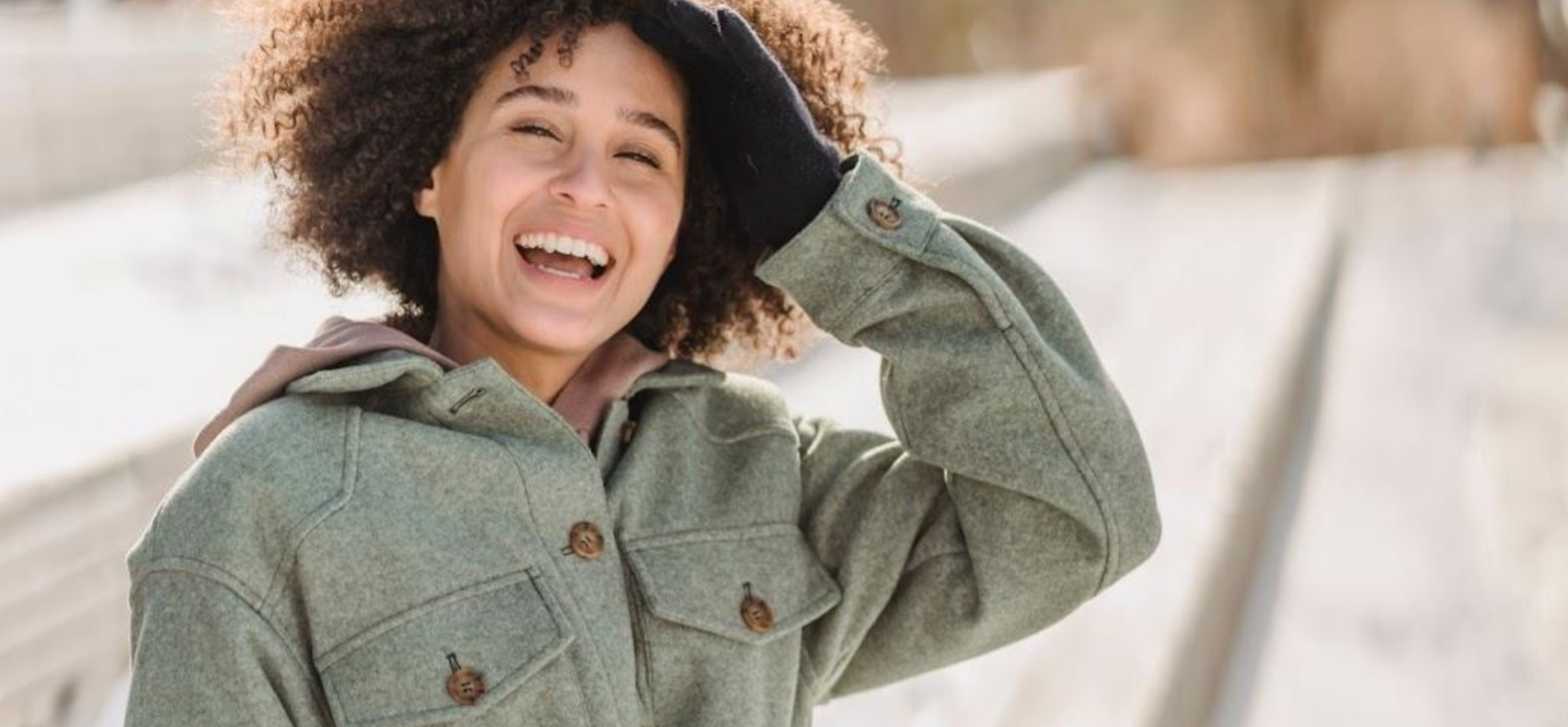 Smiling woman outside for her mental health in winter.