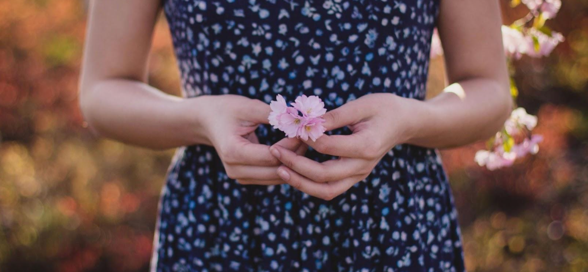 Woman holding pink blossom for spring