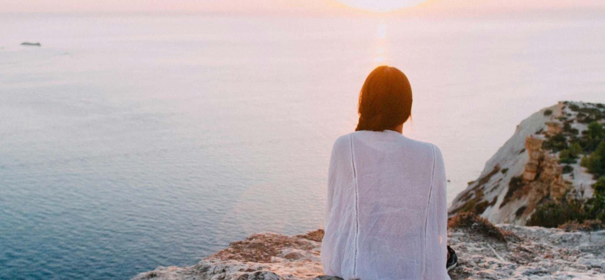 Woman relaxing and overlooking the sea