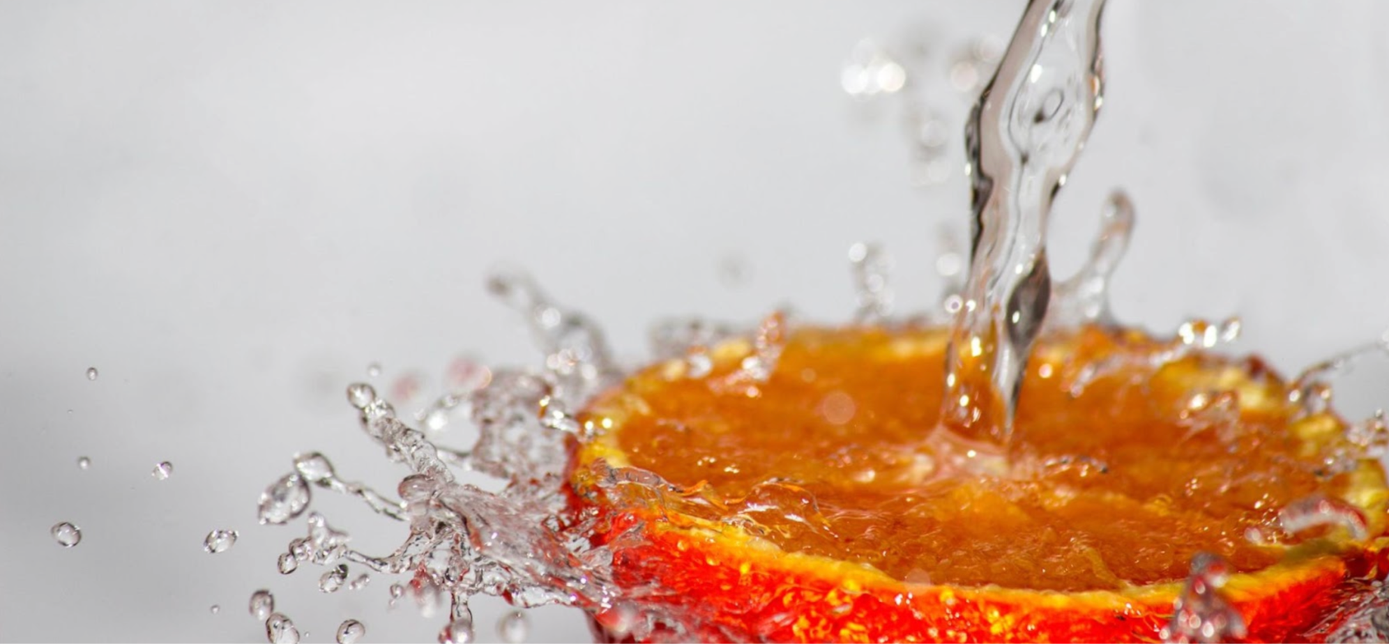 Freshwater splashing down on an orange for vitamin C
