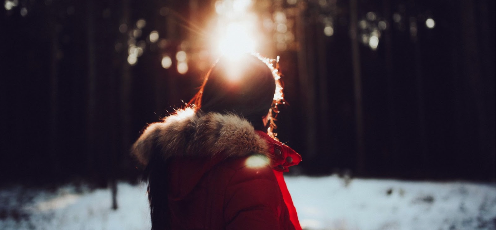 Woman in winter wearing a coat in the sunlight