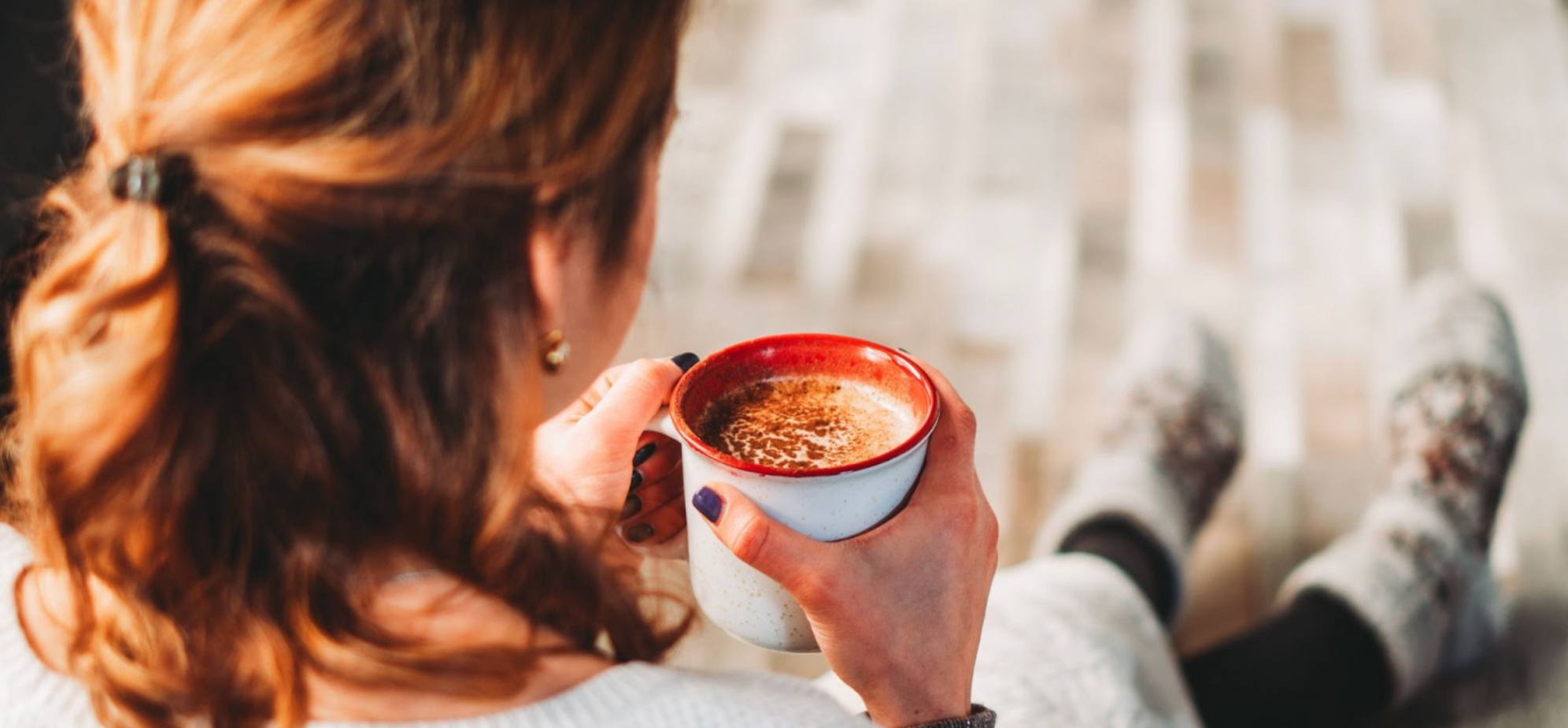 Woman sat drinking a hot chocolate