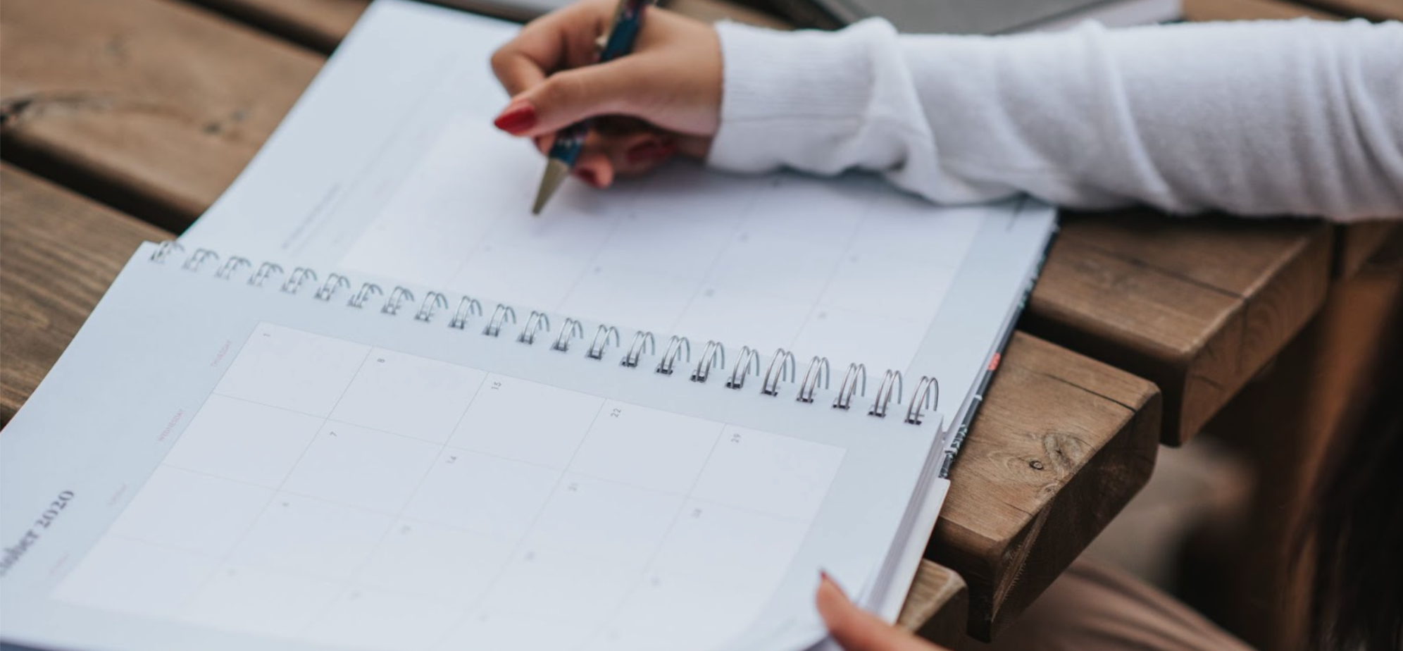 Woman writing a list in her planner