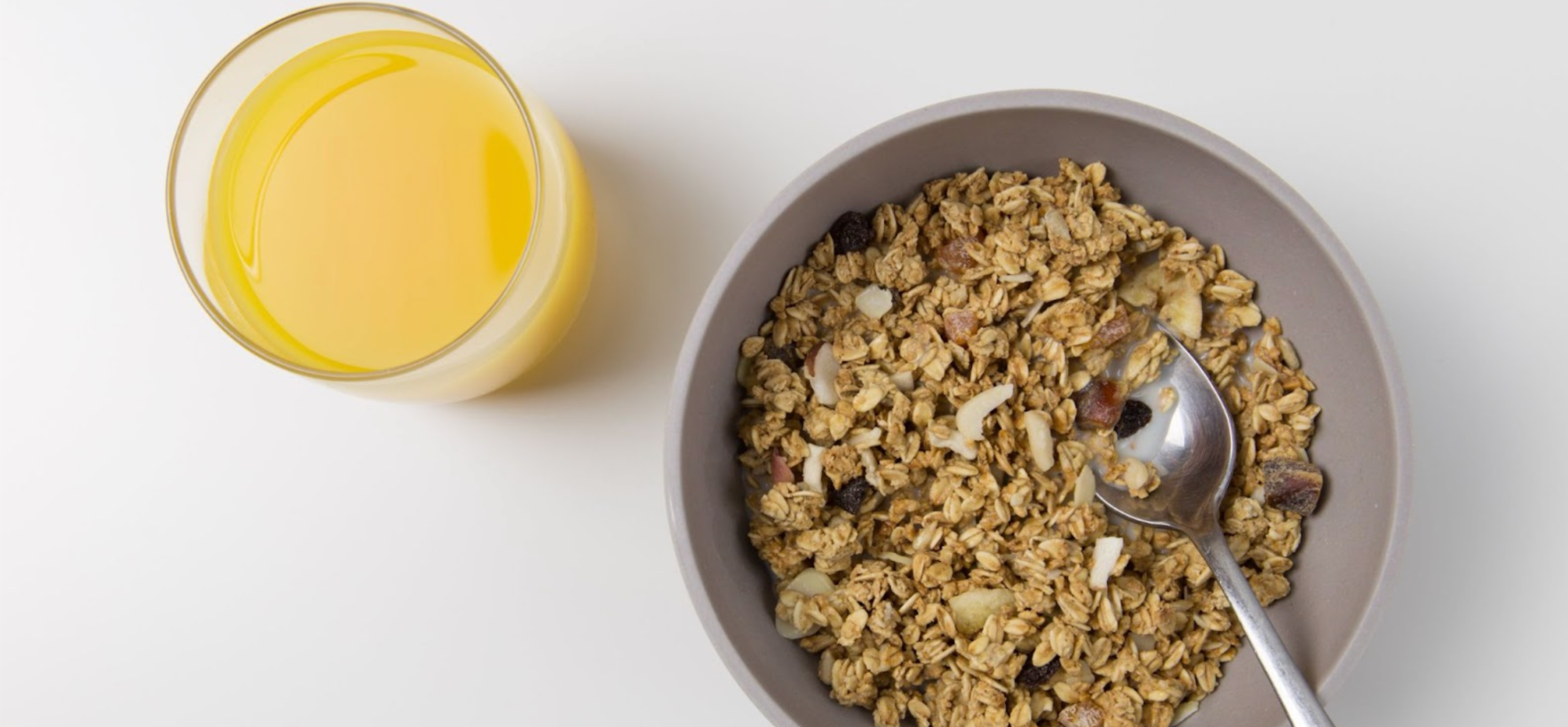 Bowl of fortified cereal with a glass of orange juice