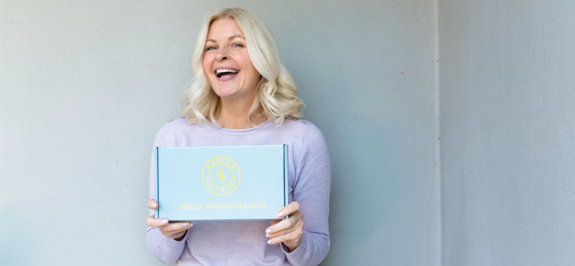 Woman holding Arella Beauty Liquid Collagen Supplement for Veganuary