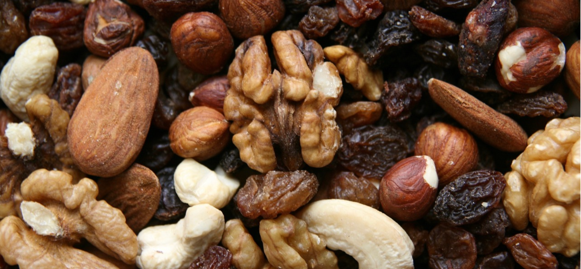 Nuts, seeds and dried fruits for a healthy Christmas, including walnuts, almonds, raisins and hazelnuts