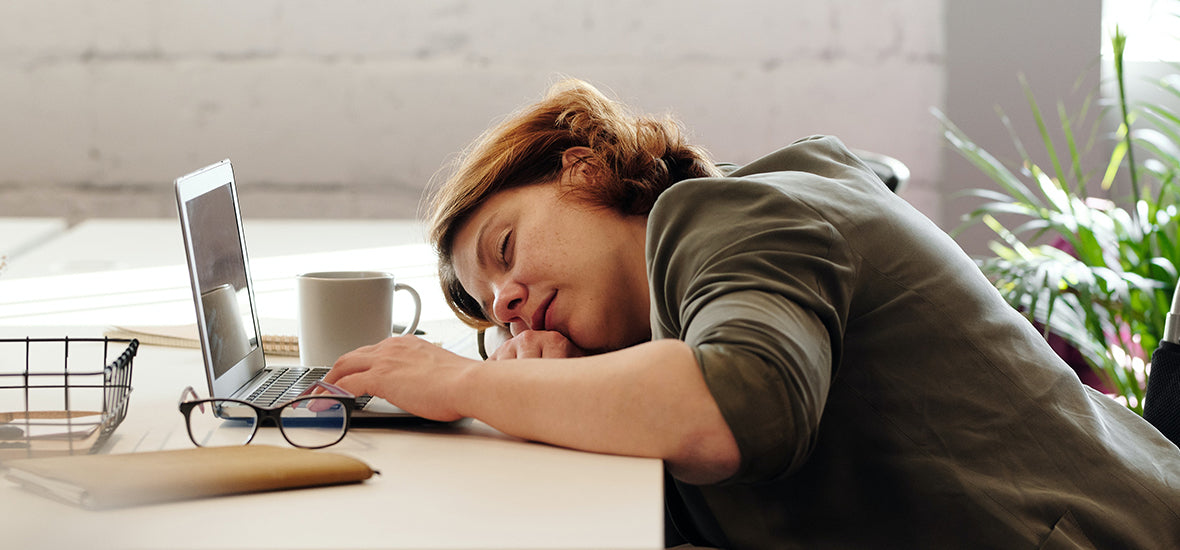 Woman in wheelchair asleep at her work desk from tiredness and needing to take collagen supplements.