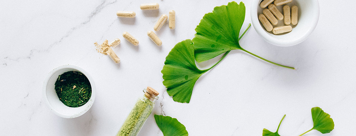 Collagen supplements and powder in bowls and a glass bottle.