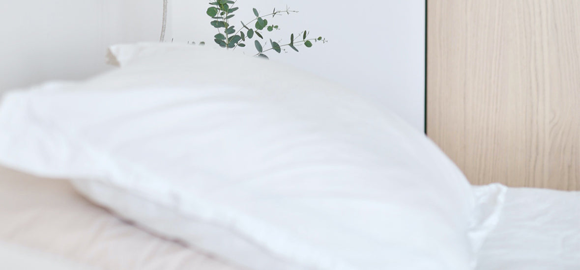 White bed and pillow for a good night’s sleep to boost collagen.