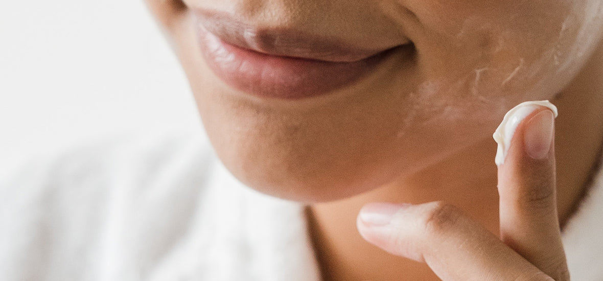 Woman applying moisturiser on her face during her liquid collagen for skincare.