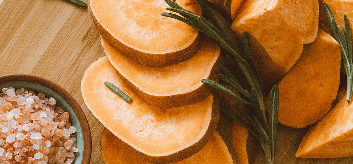 Sliced sweet potato and sprigs of rosemary for an autumn superfood.