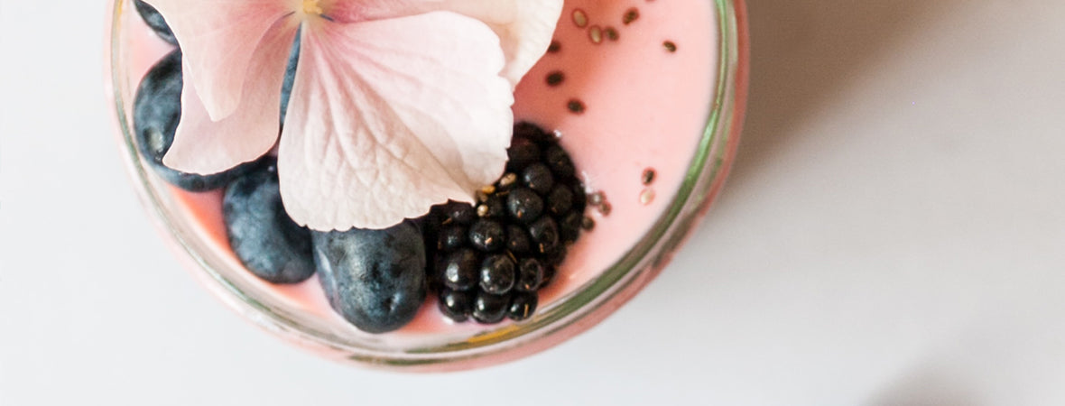 Collagen smoothie, pink with a pink flower, chia seeds, blueberries and blackberries.