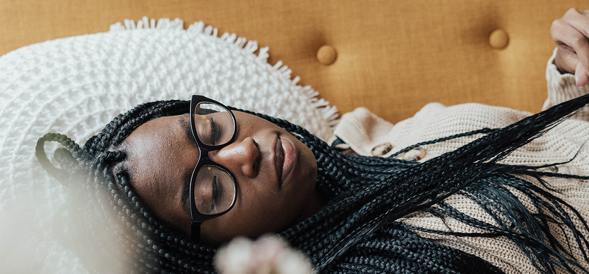 Woman wearing glasses and sleeping.
