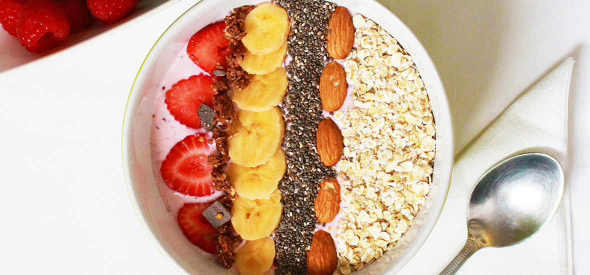 Bowl of porridge with fruits, nuts and seeds.