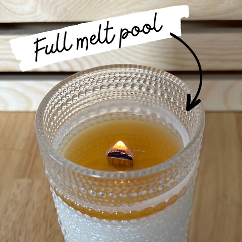 Picture of a candle with a full melt pool (the wax has melted to the edge of the container).
