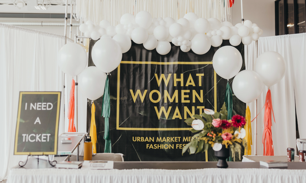 What Women Want banner with white balloon garland