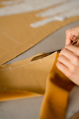 furniture maker is cutting fabric