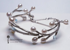 Large articulated silver bracelet with a branch design, blue topaz and white pearls