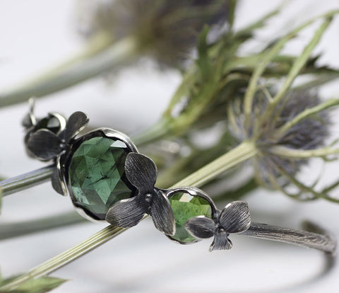 Silver cuff set with green facetted tourmalines, orchid design