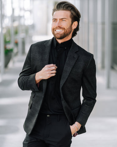 man in suit outside office building, confident for his interview and wearing black dress collar polo