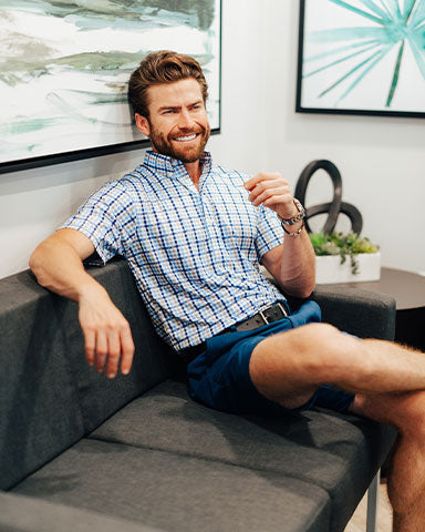 man wearing dress collar polo in office discussing basketball march madness brackets