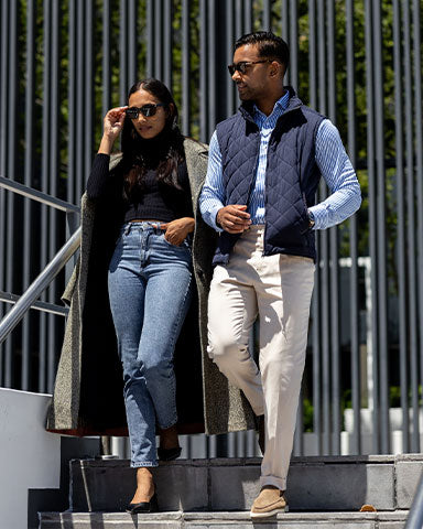 man and woman walking down stairs and man wearing blue and white stripe long sleeve dress shirt