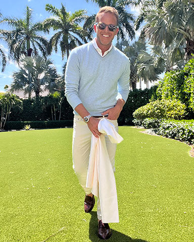 man wearing cotton v-neck in preppy style at horse track