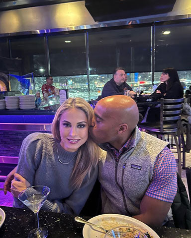 tiki barber with woman at dinner and watching the sports draft