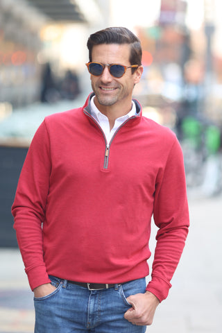 man wearing red Cloud heather cotton pullover on street.