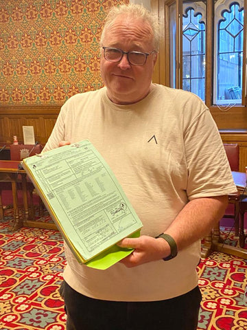 Chris Markland shows a small flight carnet to the parliamentarians 