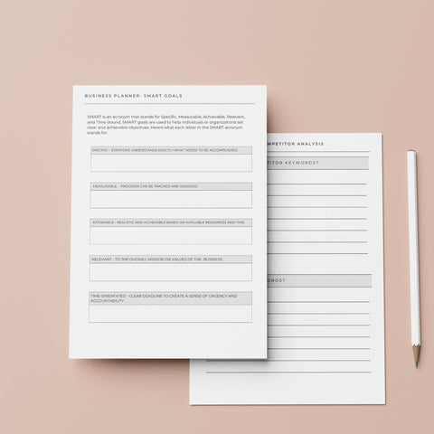 two pages from the launching your shopify business planner and branding workbook on a table with a pen