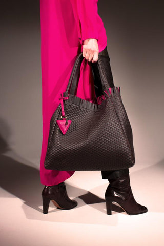 a woman with a ghibli bag