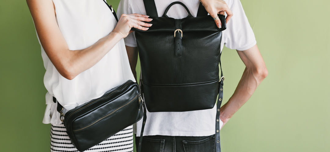 a man with a backpack on his back and a woman with a leather bag over her shoulder