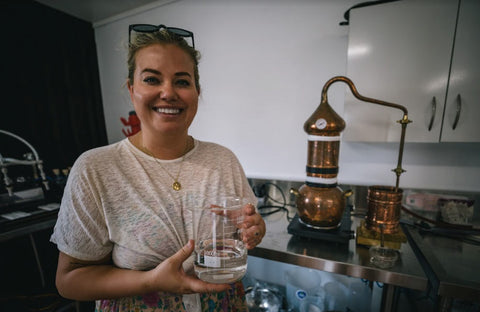 Liz Carlson holding her very own gin after taking a gin crafting class with Papaiti Gin