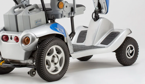 close up of mobility scooter and side view of wheels and battery