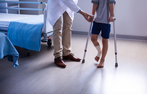 Doctor with patient who has broken foot