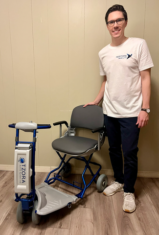 Evan, the owner of Restore Mobility with Tzora scooter