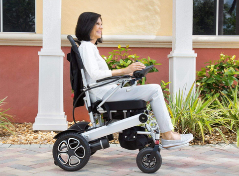 woman riding power wheelchair outside