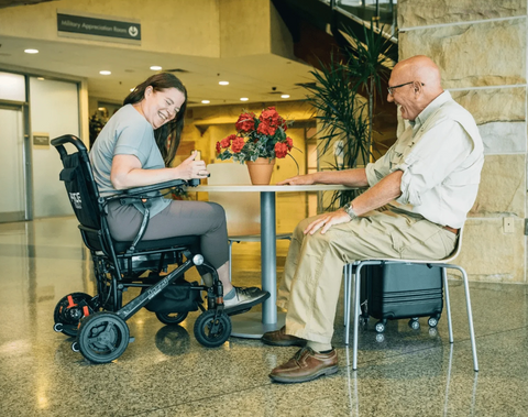 women in wheel chair siting with older man