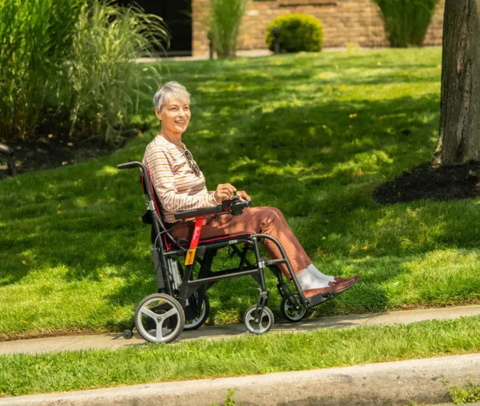 women in wheelchair on sidewalk outside