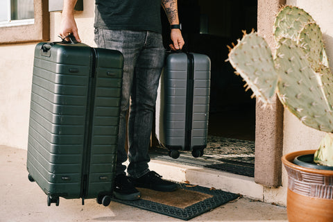 man holding luggage for travel