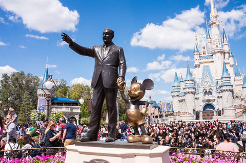 crowd around walt disney and mickey mouse statue