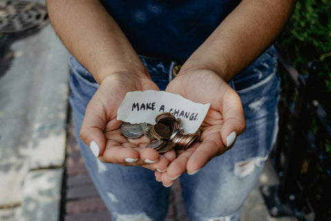 women holding change and a note that says "make a change"