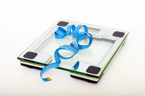 weight scale with blue measuring tape on top