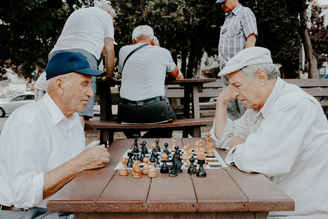 elderly men in the park playing chess