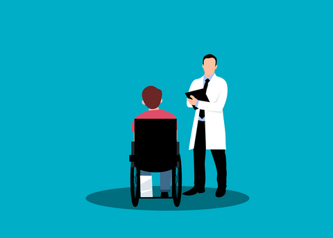 doctor next to man in wheelchair