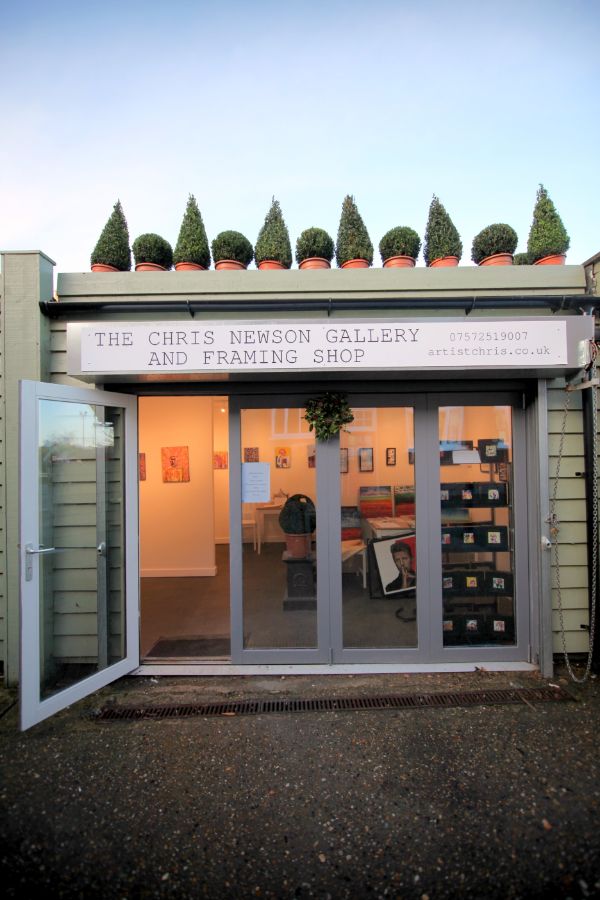 outside looking in to Chris Newson's art gallery and framing shop