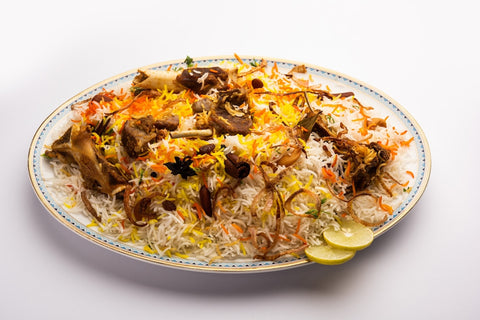 plate of arabic food, mutton served with rice, lime and spices