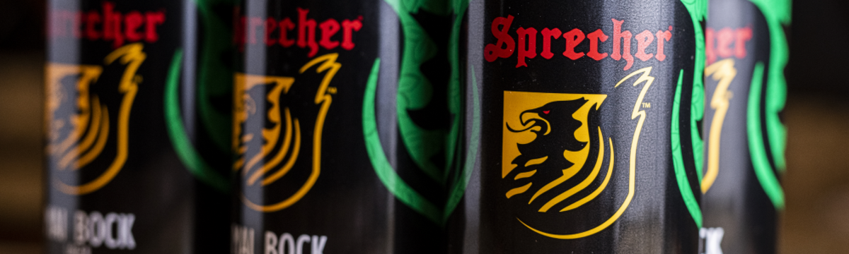 A close-up of a 6-Pack of Sprecher Mai Bock Cans
