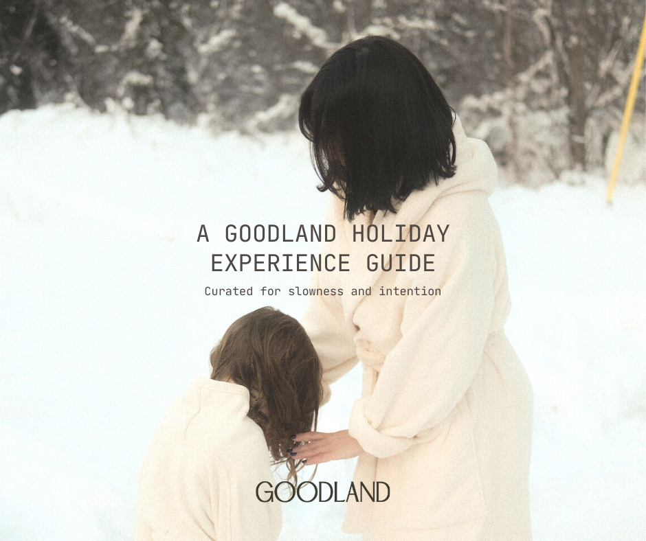 Woman with a child in the snow, with overlayed text "A GOODLAND Holiday Experience Guide"